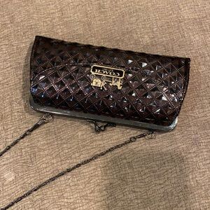 Purse with chain strap and decorative coach emblem